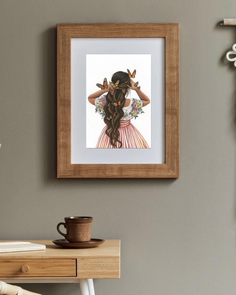 May include: A framed illustration of a woman with long brown hair decorated with butterflies. She is wearing a pink and white striped dress with floral embroidery on the sleeves. The background is white.