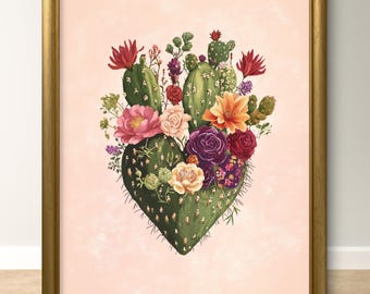 Può includere: Una stampa incorniciata di un cactus a forma di cuore con fiori colorati che sbocciano. Il cactus è verde e i fiori sono rosa, rossi, gialli e viola. Lo sfondo è rosa chiaro.