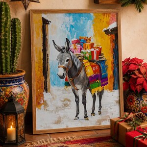 May include: A framed painting depicting a grey donkey carrying a stack of colorful wrapped gift boxes on its back. The donkey wears a harness and a vibrant, multi-colored blanket. The background shows a snowy path between yellow walls.