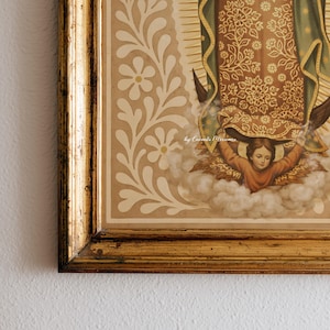 May include: A framed religious print featuring a detailed illustration of a figure with a green and gold patterned garment, and a child in a cloud. The frame is gold with a distressed finish, and the background is a beige color with white floral accents.