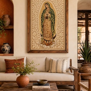 May include: A framed religious artwork depicting a figure in a green and gold robe, hands clasped in prayer. The artwork is set against a beige background with floral patterns. The image is displayed above a wooden sofa with decorative pillows.