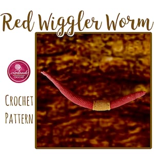 May include: A red crocheted worm with a gold band, labelled "Red Wiggler Worm" and "Crochet Pattern." The Cranbrook Crochet logo is visible. The worm is set against a textured, brown background.