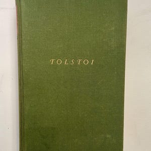 May include: A green hardcover book with the word "TOLSTOI" printed in gold on the front cover.