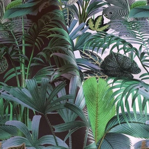 May include: A close-up of a dark green and white tropical leaf print fabric. The fabric features a variety of palm leaves and other tropical plants.