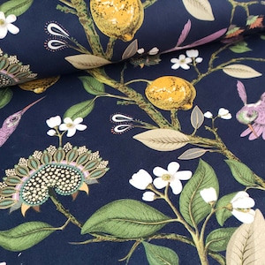 May include: A dark blue fabric with a repeating pattern of hummingbirds, lemons, and white flowers. The fabric has a textured surface and a subtle sheen.