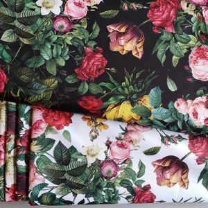 May include: Two pieces of fabric with a floral print. The top piece is black with red, yellow, and pink flowers. The bottom piece is white with red, yellow, and pink flowers.