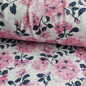 May include: Gray fabric with a pink and blue floral print. The fabric features a repeating pattern of roses and leaves.