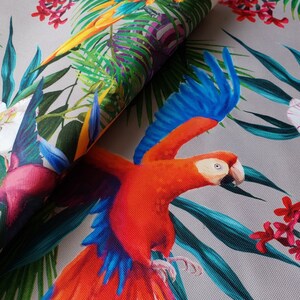 May include: A tropical fabric featuring a vibrant red and blue parrot with green and blue leaves, white orchids, and pink flowers.