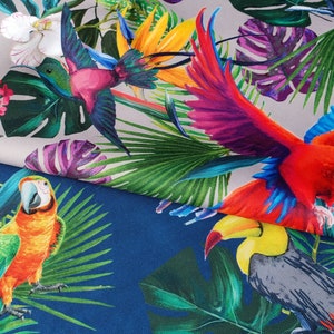 May include: A colorful fabric with a tropical print featuring parrots, hummingbirds, and lush green foliage. The fabric has a white background with a blue section at the bottom.