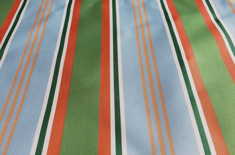 May include: Striped fabric with alternating bands of light blue, white, orange, green, and red.