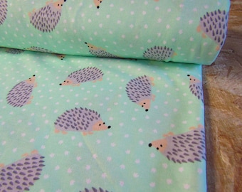 May include: Mint green fabric with a white polka dot pattern and a repeating design of gray hedgehogs.