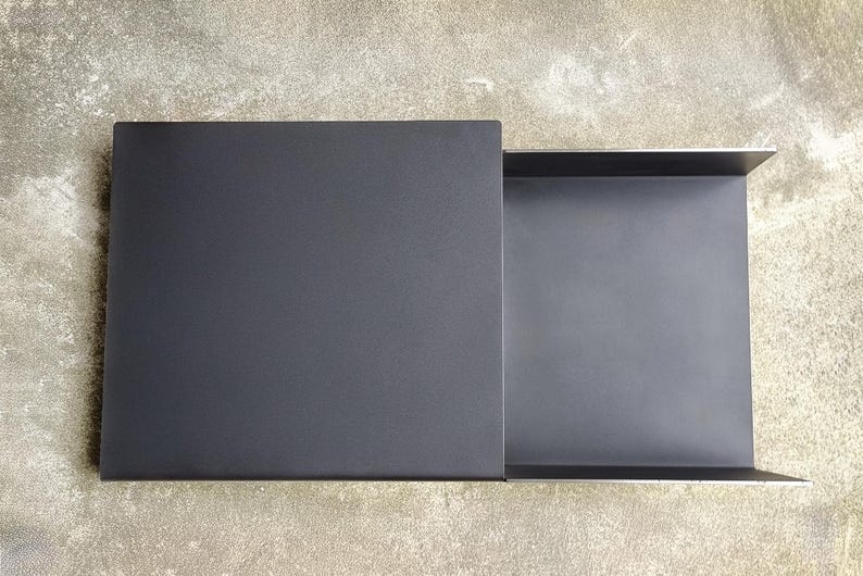 May include: A black metal tray with a sliding drawer. The tray is open and the drawer is pulled out.