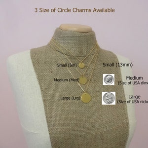 May include: Three gold circle charms of different sizes on a mannequin. The sizes are labeled as small (13mm), medium (size of a US dime), and large (size of a US nickel).