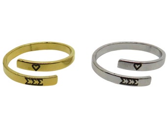 May include: Two gold and silver rings with a heart and the letters 'ΣΣΣ' engraved on them. The rings are open and can be adjusted to fit different finger sizes.