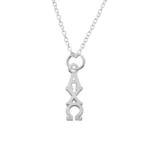 May include: A silver-colored pendant necklace featuring the Greek letters Alpha, Chi, and Omega. The pendant hangs from a delicate chain, and the letters are vertically aligned. The necklace is displayed against a white background.