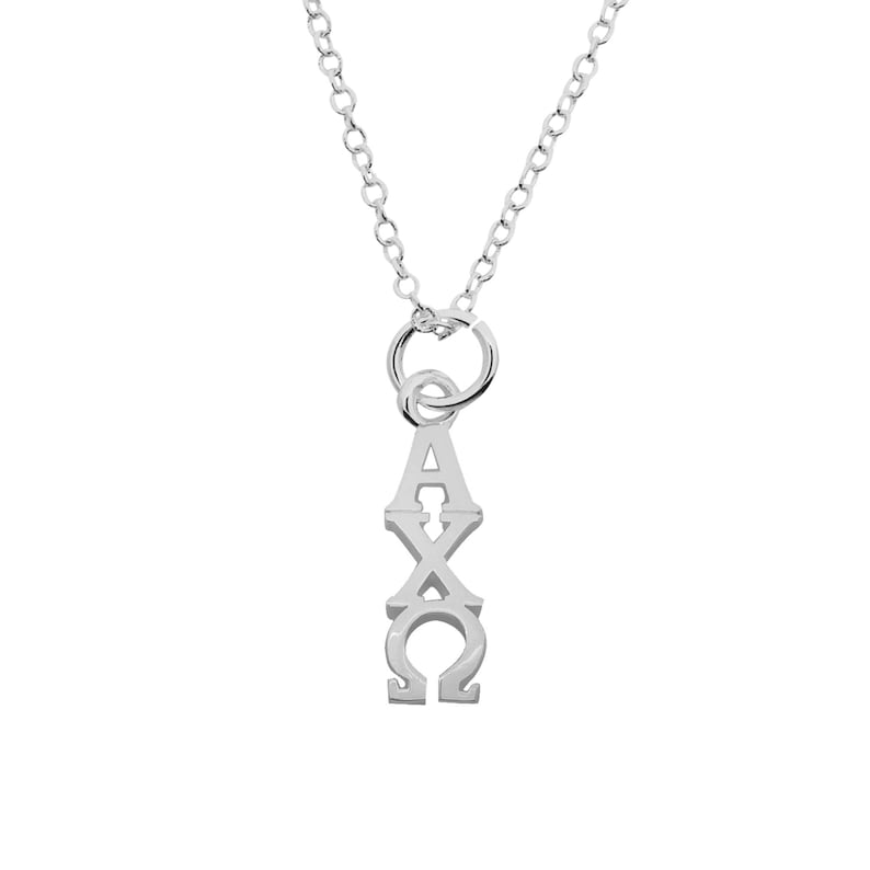 May include: A silver-colored pendant necklace featuring the Greek letters Alpha, Chi, and Omega. The pendant hangs from a delicate chain, and the letters are vertically aligned. The necklace is displayed against a white background.