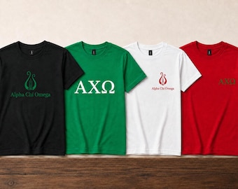 May include: Four short-sleeve t-shirts in black, green, white, and red. The black shirt features a green lyre logo and "Alpha Chi Omega" text. The green shirt displays white "AXΩ" letters. The white shirt has a red lyre logo and text. The red shirt has "AXΩ" text.