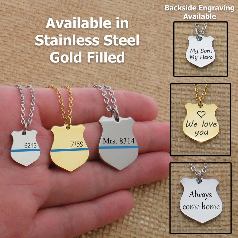 May include: Three silver and gold necklaces with a police badge pendant. The pendants are engraved with the text "6243", "7159", and "Mrs. 8314". The necklaces are available in stainless steel and gold filled.