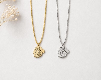 May include: Two necklaces with thin metal chains, one in a gold tone and one in a silver tone. Each necklace features a small, flat pendant shaped like the profile of a lion's head with stylized, flowing mane details and a simple, clean outline.