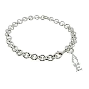 May include: A silver chain bracelet with a charm that says "ACE" hanging from it.