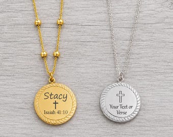 May include: Two round pendant necklaces, one gold-toned with a beaded chain and one silver-toned with a standard link chain. The gold pendant is engraved with 'Stacy', a cross, and 'Isaiah 41:10'. The silver pendant features a cross and 'Your Text or Verse'.