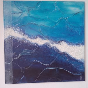 May include: Abstract ocean wave painting in shades of blue and white. The artwork features textured brushstrokes, creating a sense of depth and movement. The painting captures the dynamic energy of the sea.