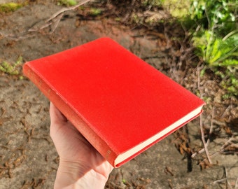 May include: A red hardcover book with a plain cover.