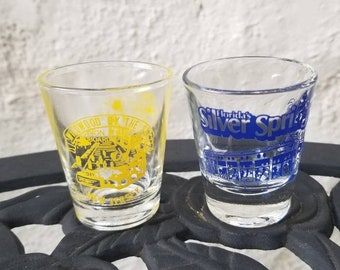 Two Souvenir Shot Glasses, Florida's Silver Springs, Wildwood By The Sea On The Boardwalk New Jersey, Blue, Yellow