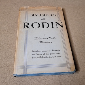 May include: A vintage book titled "DIALOGUES with RODIN" by Helene von Nostitz Hindenburg. The cover is light blue and cream with black text. The book includes drawings and letters of the artist, published for the first time.