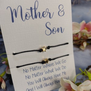May include: Two black string bracelets with gold star charms. The bracelets are displayed on a white card with the text "Mother & Son" and "No Matter Where We Go No Matter What We Do You Will Always Have Me And I Will Always Have You!"