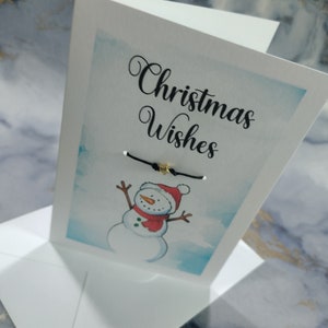 Weihnachtskarte mit Weihnachtsschneemann. Grußkarte mit Wunscharmband, Frohe Weihnachten, Frohe Weihnachten