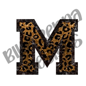May include: A large letter M with a black outline and a gold and black leopard print inside. The letter has a distressed look.