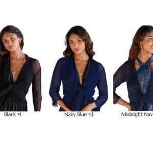 May include: Three cropped shrugs with long sleeves and a front-tie closure. The first is black labeled Black #1, the second is navy blue labeled Navy Blue #2, and the third is a dark midnight blue labeled Midnight Navy #112, all in a knit fabric.