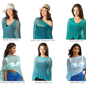 May include: A collection of six lightweight, semi-sheer knit ponchos in various shades of blue and green, labeled as Robin Blue #125, Reef Teal Turquoise #40, Teal Green #21, Seafoam Mint Green #22, Turquoise Blue #4, and Baby Blue #30.