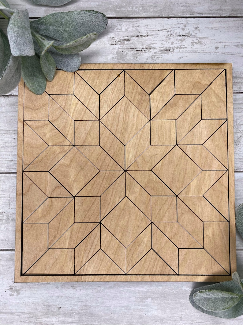 May include: A wooden geometric design puzzle with a light brown finish. The puzzle is made up of many small pieces that fit together to create a larger design.