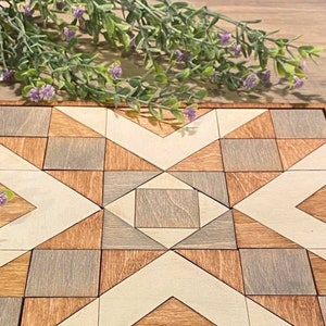 May include: A wooden geometric puzzle with a starburst design. The puzzle is made up of squares and triangles in shades of brown, grey, and white.