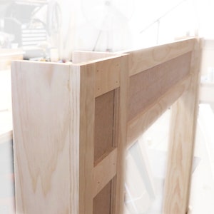 May include: A wooden fireplace mantel with a natural finish. The mantel is made of unfinished wood and has a simple design.