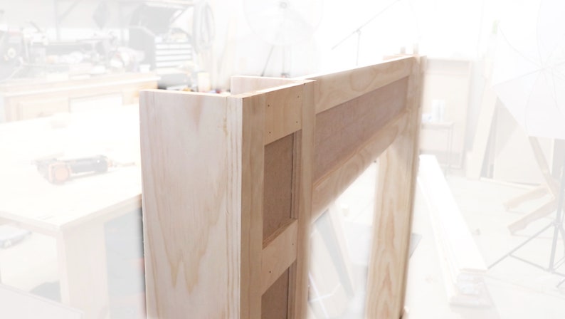 May include: A wooden fireplace mantel with a natural finish. The mantel is made of unfinished wood and has a simple design.