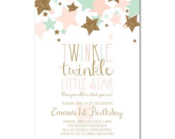May include: Twinkle Twinkle Little Star themed first birthday party invitation with gold glitter stars and pink and green stars on a white background. The invitation includes the text "Twinkle Twinkle Little Star", "One year old is what you are!" and "Emma's 1st Birthday". The invitation also includes the date, time, location, and RSVP information.