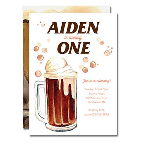 May include: A watercolor illustration of a root beer float with a white background. The text "AIDEN is turning ONE" is at the top of the card. The text "Join us in celebrating!" is at the top of the card. The text "Sunday, 9/3 at 12pm Alden's House 850 Meadow Trail Birchwood, IN RSVP by 8/26 Laura 123-456-7890" is at the bottom of the card. The text "Paperie Off Park" is at the bottom of the card.
