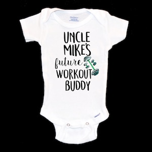 May include: White baby onesie with black text that reads "Uncle Mike's future workout buddy" with a green and black dumbbell graphic.