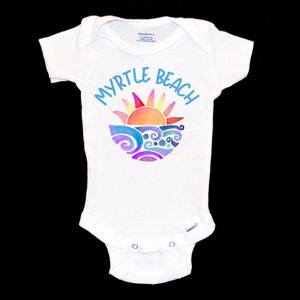 May include: White baby onesie with a colorful graphic of a sun setting over waves and the text "Myrtle Beach" in blue.