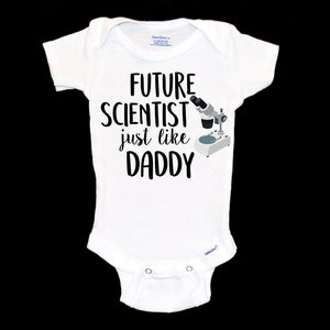 May include: White baby onesie with black text that reads "Future Scientist just like Daddy" and a small illustration of a microscope.