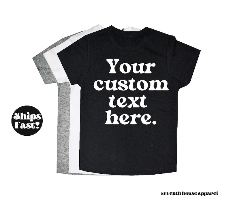 May include: Three t-shirts in black, white and grey with the text "Your custom text here." printed in white on the black t-shirt.