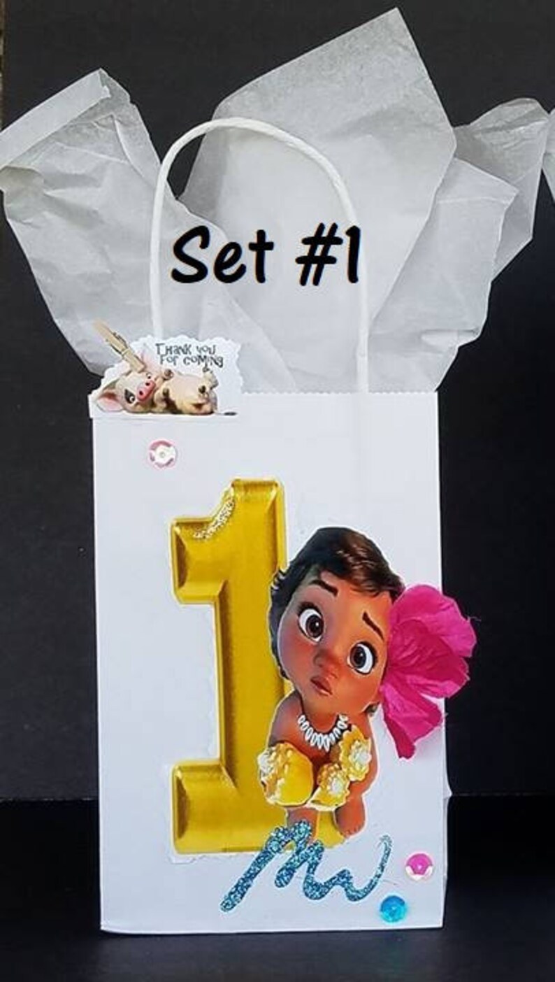 May include: A white paper gift bag with a gold number one, a cartoon character with brown hair and a pink flower, and the text "Set #1".