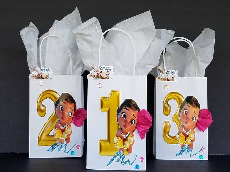 May include: Three white gift bags with handles, each decorated with a gold number, a cartoon character, and pink flowers. The numbers are 2, 1, and 3. The bags have the text "Thank you for coming" on them.