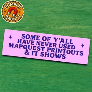 May include: A pink bumper sticker with the text "SOME OF Y'ALL HAVE NEVER USED MAPQUEST PRINTOUTS & IT SHOWS" in dark blue. A round magnet with a red horseshoe magnet graphic is in the upper left corner.