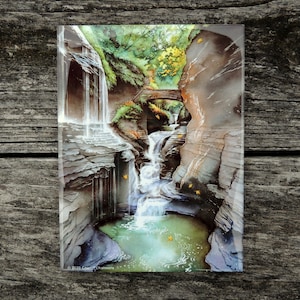 May include: Waterfall cascading down a rocky gorge with lush green foliage and fallen autumn leaves. The water is clear and the rocks are gray and brown. The image is a watercolor painting.