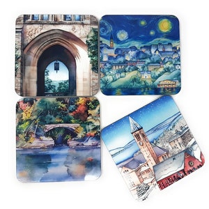 May include: Set of four square coasters featuring watercolour illustrations of various scenes. The first coaster shows a stone archway with a view of trees and a building in the background. The second coaster shows a night sky with stars and a cityscape. The third coaster shows a bridge over a river with trees and foliage. The fourth coaster shows a snowy cityscape with a tall clock tower.