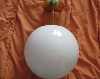 May include: A white globe pendant light fixture with a brass ceiling mount and a gold rod.